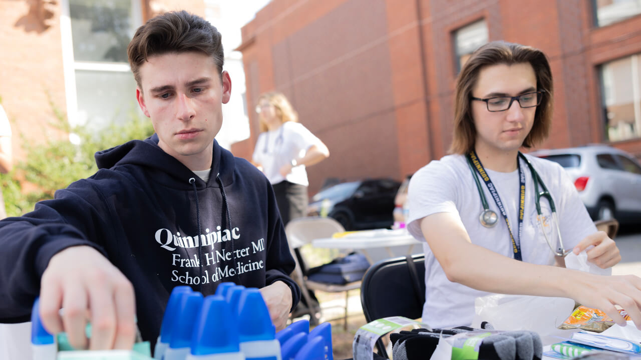 2 male medical students preparing hygiene kits