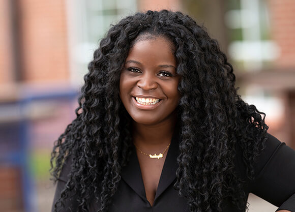 Caurice Wynter, MD `22 smiles in a portrait.